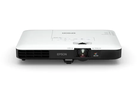 Epson EB-1785W ultra-slim Wireless Projector resting next to a laptop computer