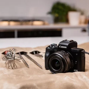 Detailed close-up of Canon EF-M 18-150mm IS STM zoom lens mounted on body