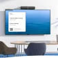 Anker PowerConf B500 mounted securely on top of an office monitor using integrated bottom clip